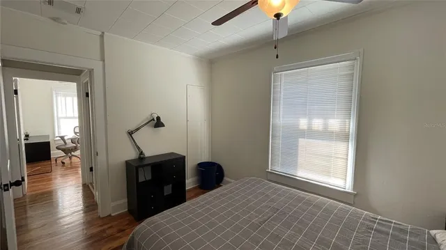 a bedroom with a bed and a chandelier