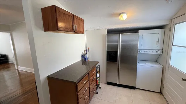 a kitchen with stainless steel appliances granite countertop a refrigerator and a microwave