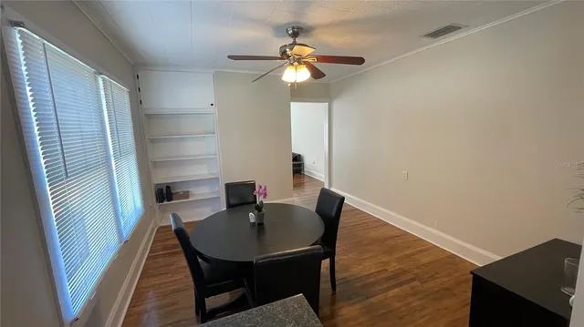 a view of a dining room with furniture and wooden floor
