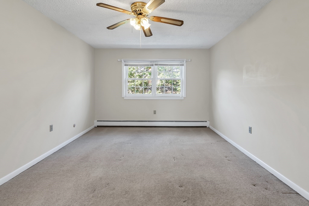35 Fernview Avenue, Unit 5 North Andover, MA 01845 - Photo 18 of 32 an empty room with a window and a fan