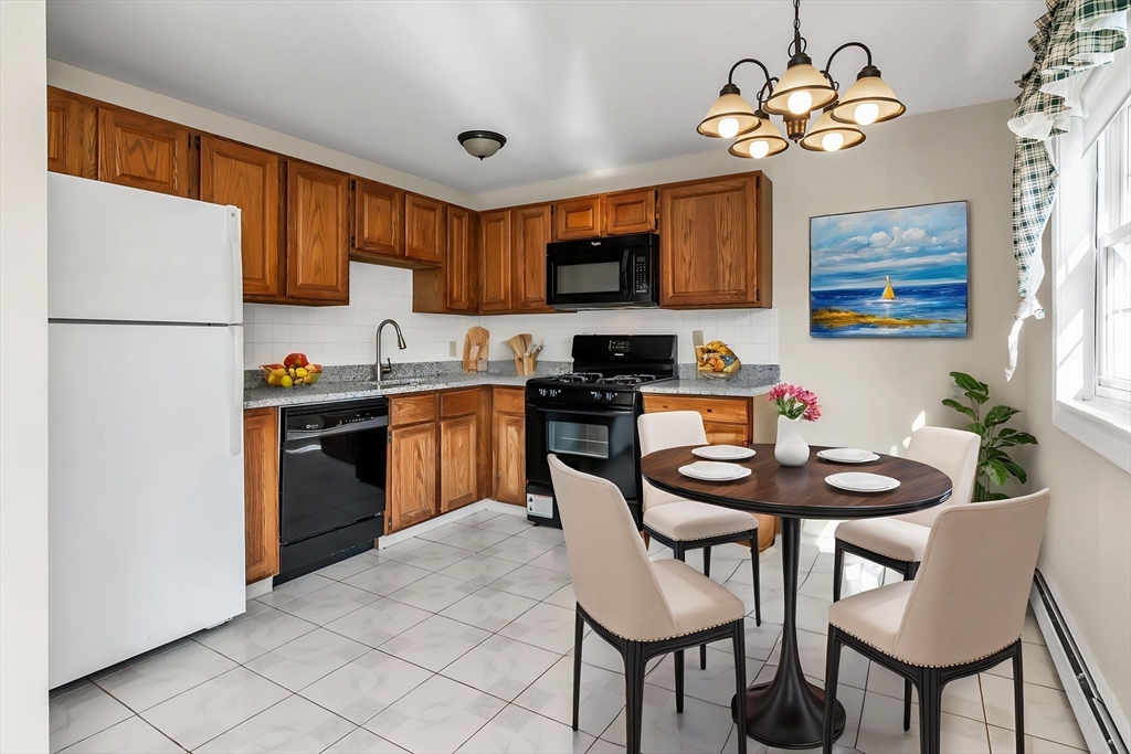 35 Fernview Avenue, Unit 5 North Andover, MA 01845 - Photo 2 of 32 a kitchen with stainless steel appliances granite countertop a sink a stove a refrigerator a dining table and chairs