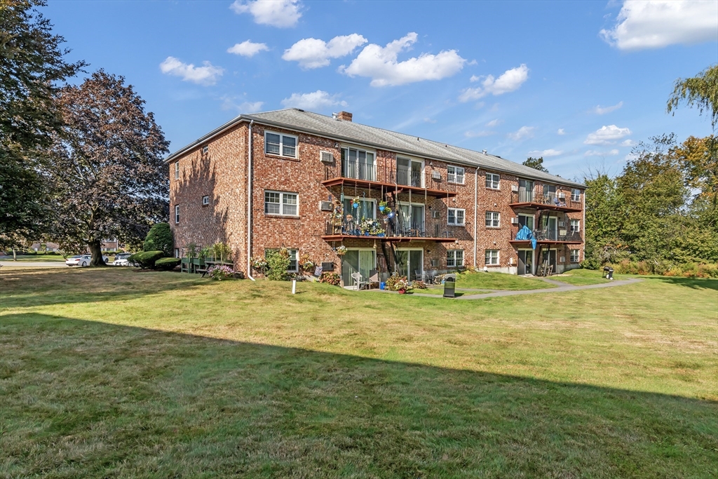 35 Fernview Avenue, Unit 5 North Andover, MA 01845 - Photo 25 of 32 a view of a house with a big yard and large trees