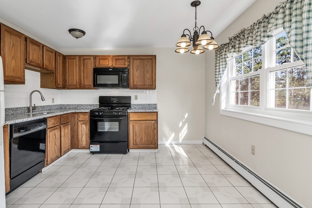 35 Fernview Avenue, Unit 5 North Andover, MA 01845 - Photo 3 of 32 a kitchen with stainless steel appliances granite countertop a stove cabinets and a sink