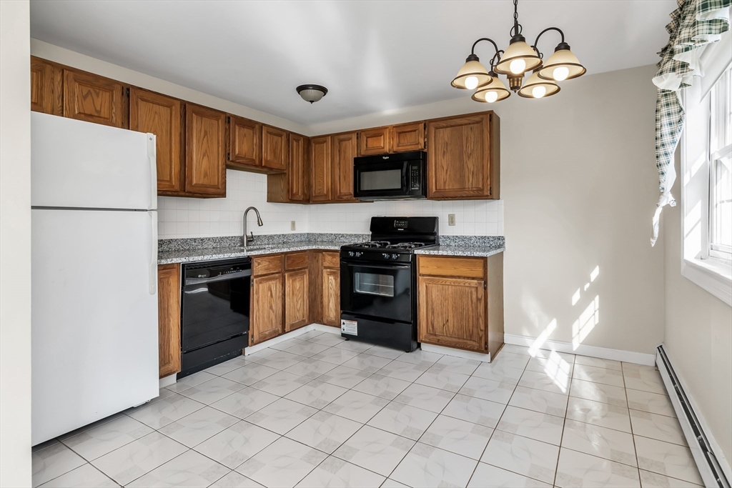 35 Fernview Avenue, Unit 5 North Andover, MA 01845 - Photo 4 of 32 a kitchen with a stove a sink and a refrigerator