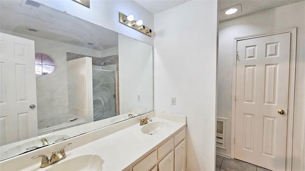 7640 Tournament Road Frisco, TX 75035 - Photo 11 of 25 a bathroom with a sink a toilet and shower