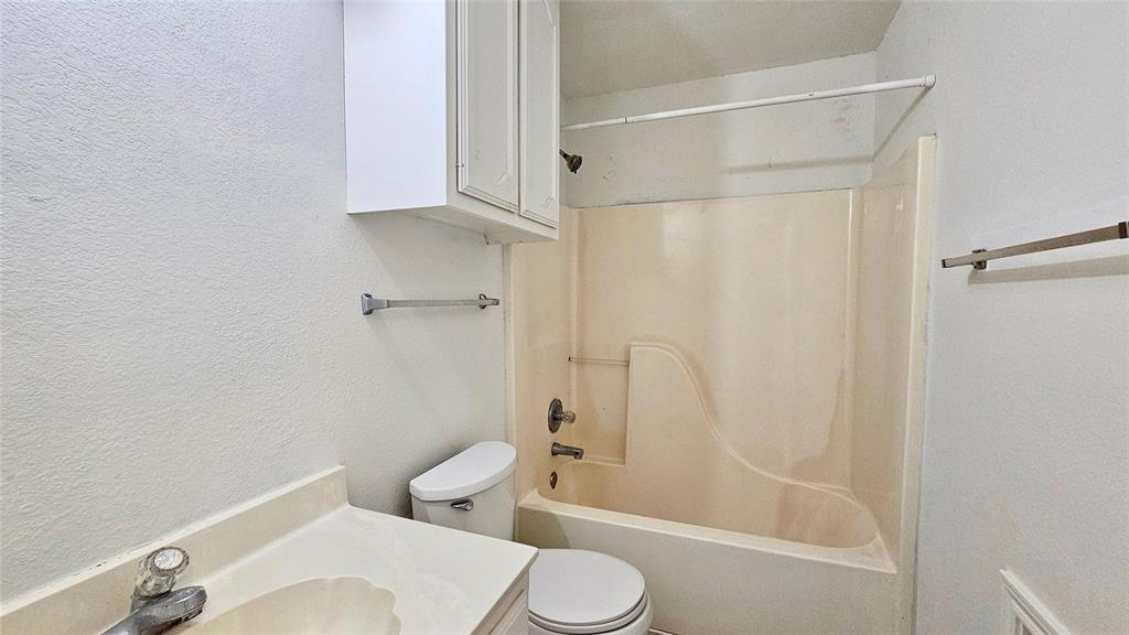 7640 Tournament Road Frisco, TX 75035 - Photo 14 of 25 a white toilet sitting next to a bath tub
