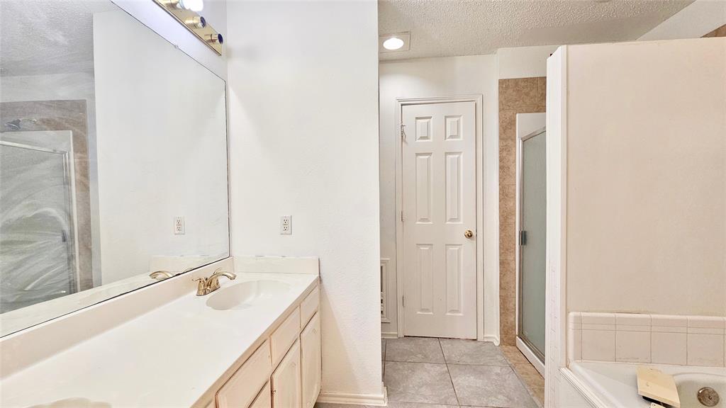 7640 Tournament Road Frisco, TX 75035 - Photo 17 of 25 a bathroom with a sink a toilet and shower
