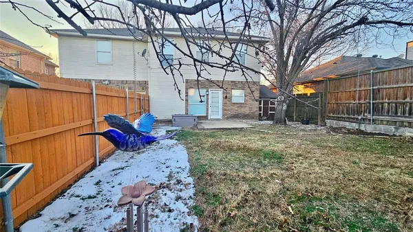 a view of a backyard with large trees