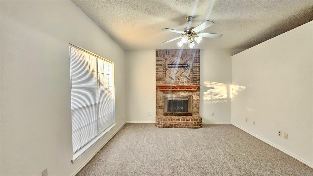 7640 Tournament Road Frisco, TX 75035 - Photo 4 of 25 an empty room with chandelier fan and windows