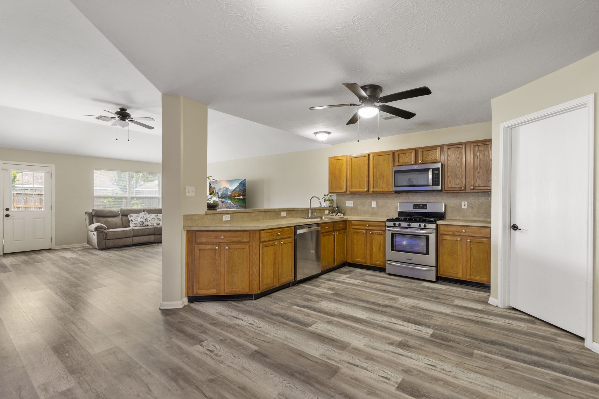 29106 Foxingham Circle Spring, TX 77386 - Photo 12 of 47 a kitchen with stove cabinets and wooden floor