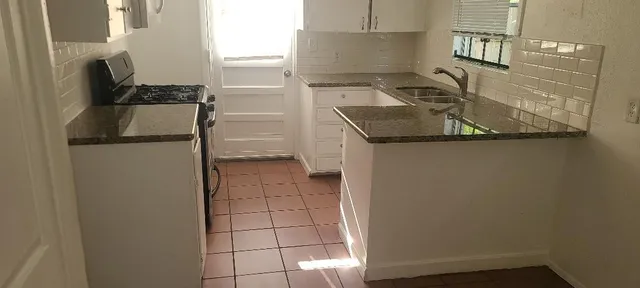 a kitchen with a refrigerator and a stove