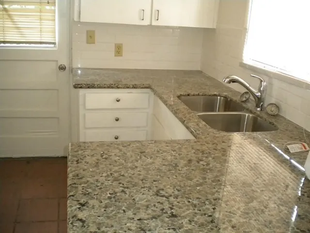 a bathroom with a sink and granite