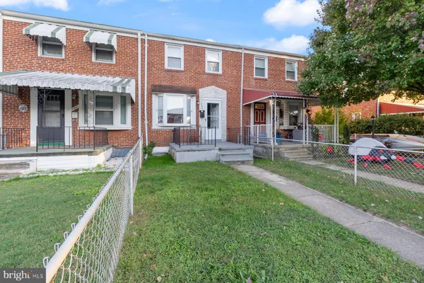 a front view of a house with a yard table and chairs