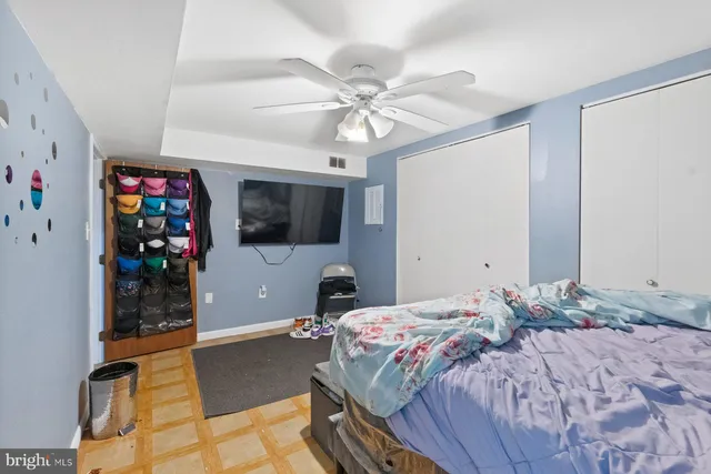 a bedroom with a bed and a flat tv screen on dresser