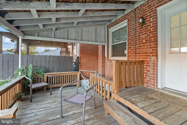 a view of a deck with chair and wooden floor