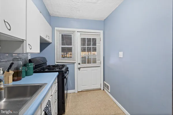 a kitchen with a sink and a stove top oven