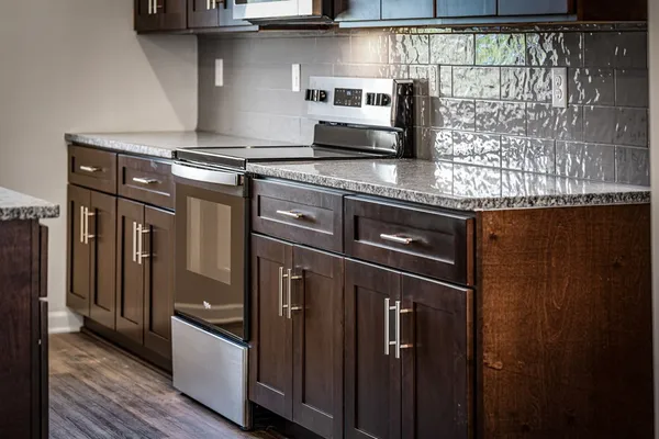 a kitchen with granite countertop a stove and a sink