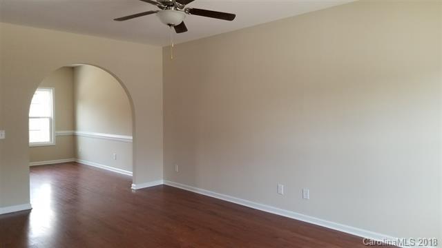 428 Windsor Gate Drive Fort Mill, SC 29708 - Photo 5 of 13 an empty room with wooden floor fan and windows