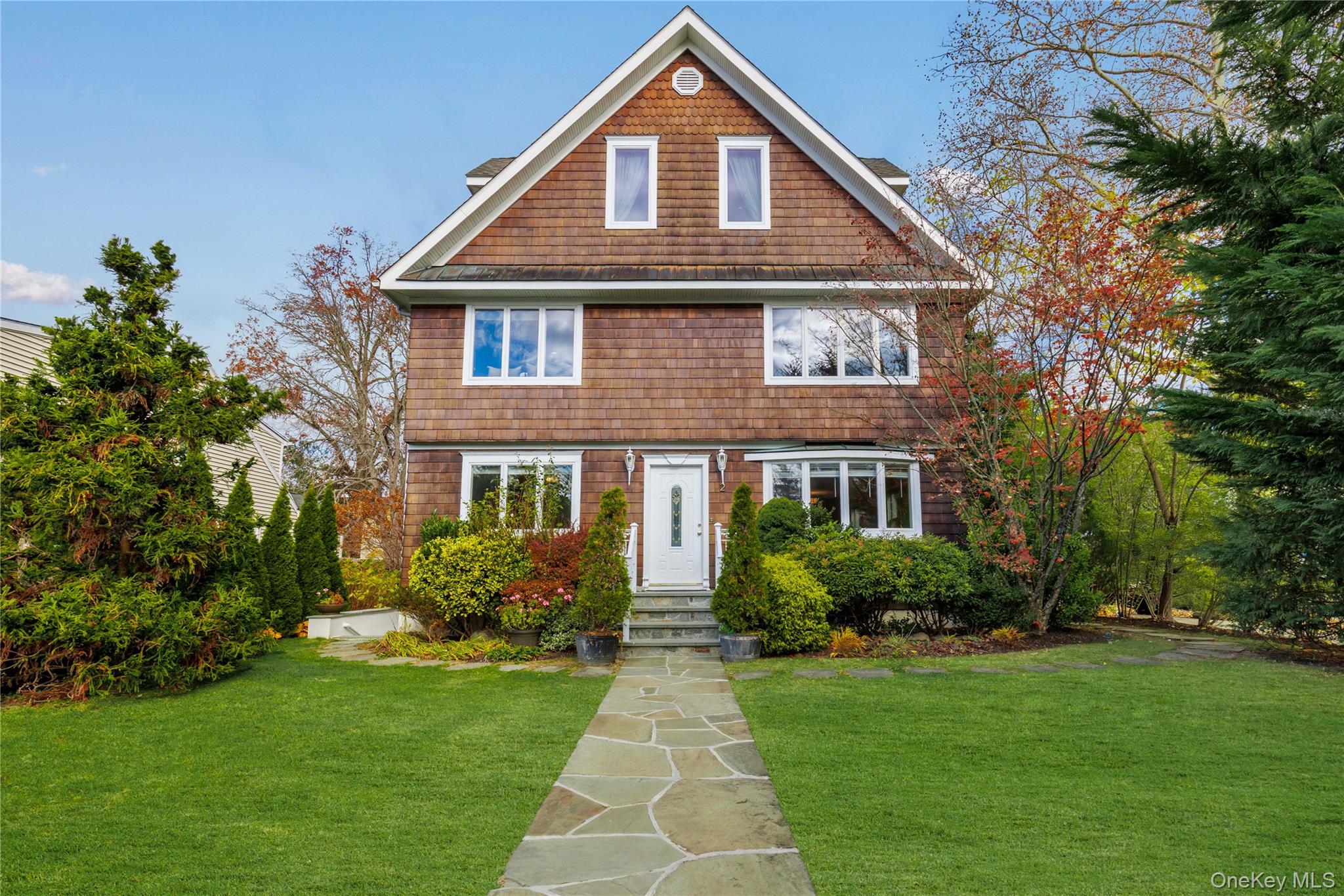 a front view of house with yard and green space