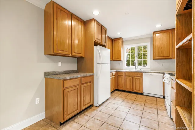 a kitchen with a refrigerator sink and cabinets