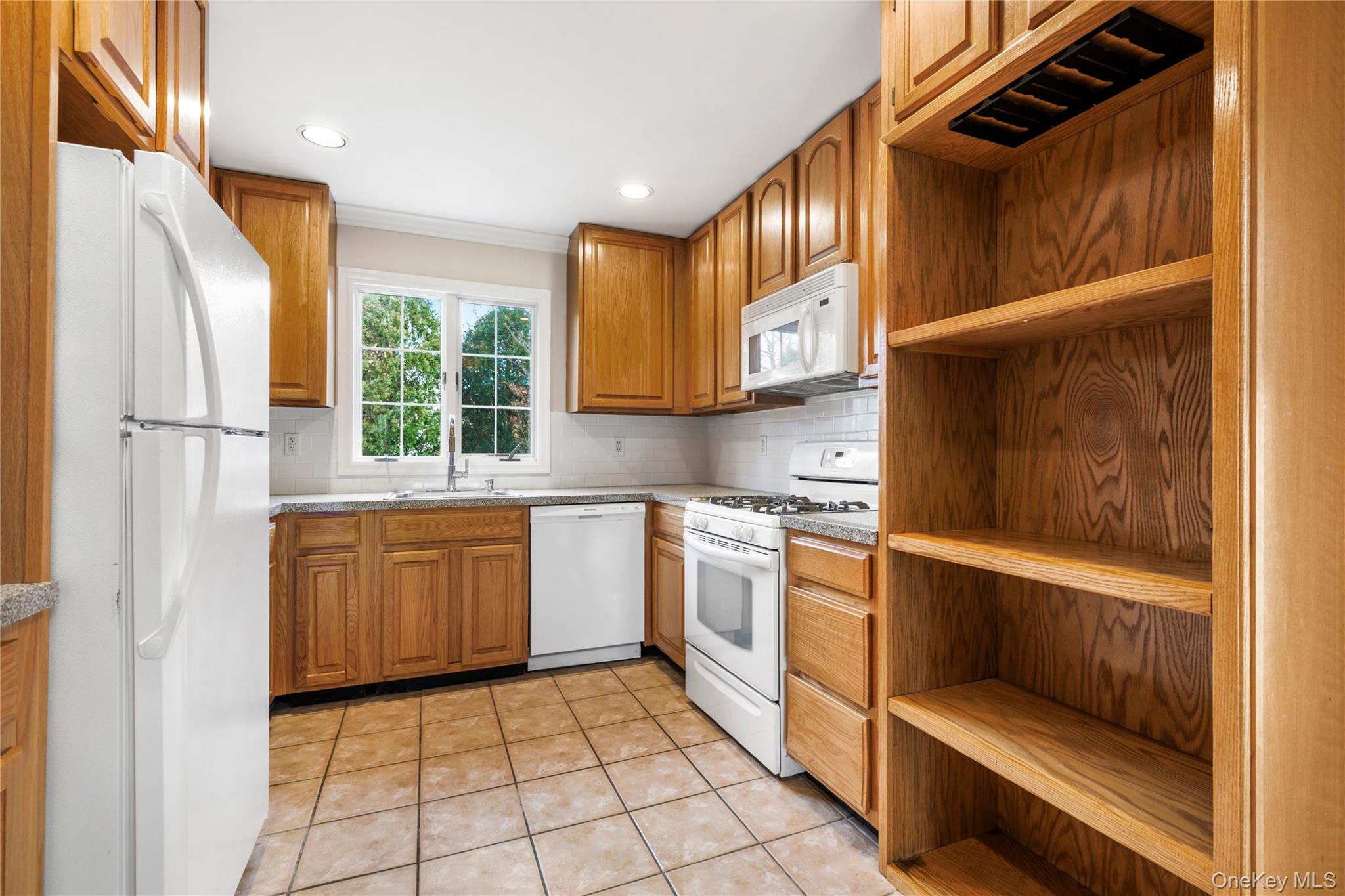 2 Goldwin Street, Unit 1 Rye, NY 10580 - Photo 6 of 18 a kitchen with stainless steel appliances granite countertop a refrigerator and a stove top oven