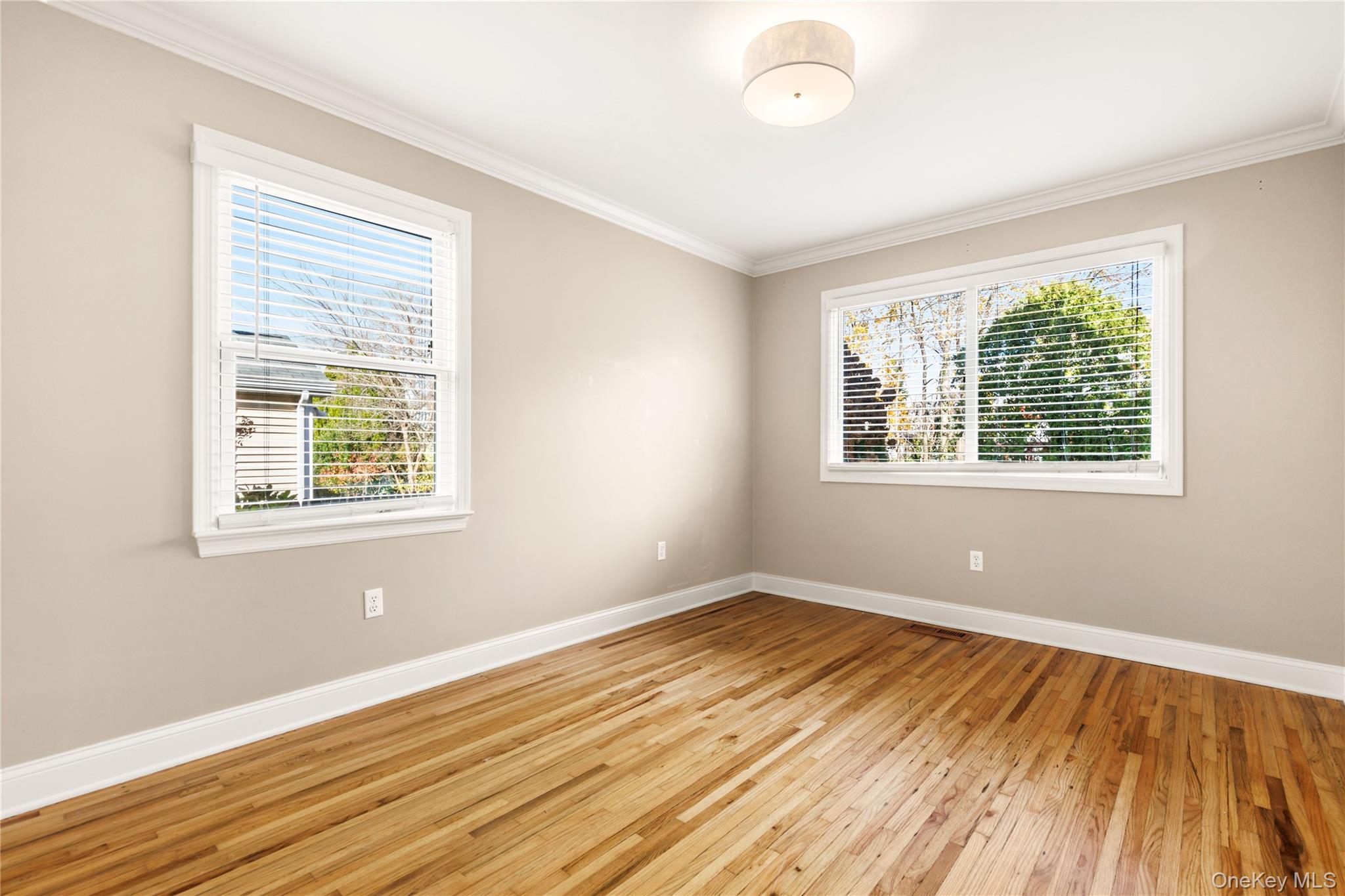 2 Goldwin Street, Unit 1 Rye, NY 10580 - Photo 7 of 18 a view of an empty room with wooden floor and a window