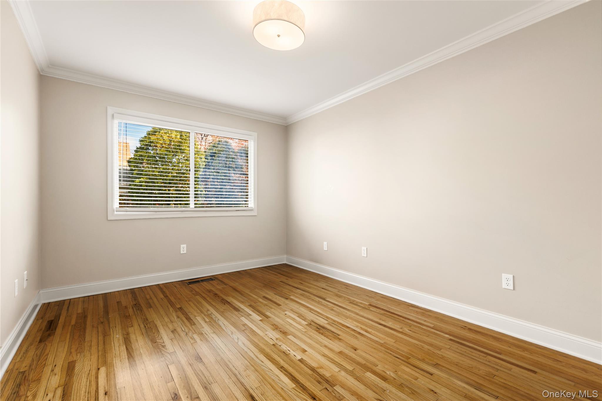 2 Goldwin Street, Unit 1 Rye, NY 10580 - Photo 8 of 18 an empty room with wooden floor and windows