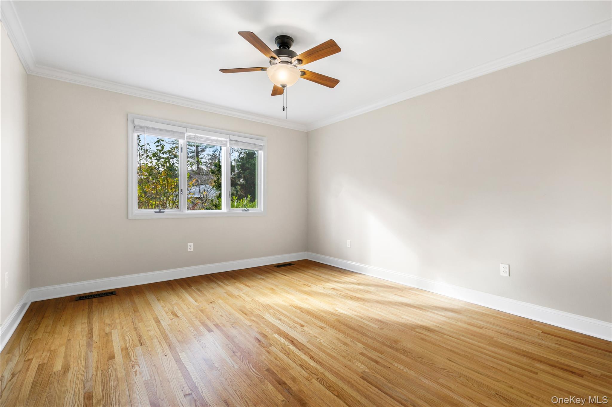 2 Goldwin Street, Unit 1 Rye, NY 10580 - Photo 9 of 18 an empty room with wooden floor and windows