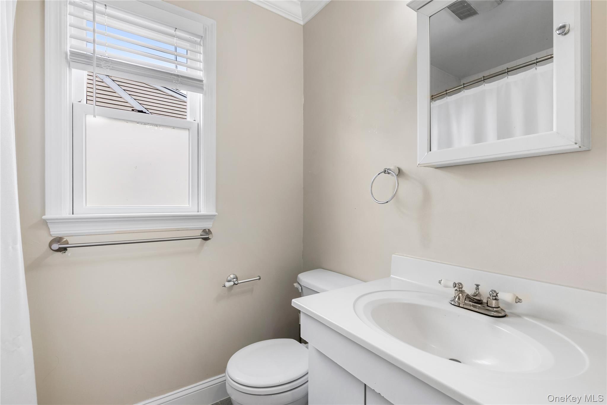 2 Goldwin Street, Unit 1 Rye, NY 10580 - Photo 10 of 18 a bathroom with a sink a toilet and a mirror