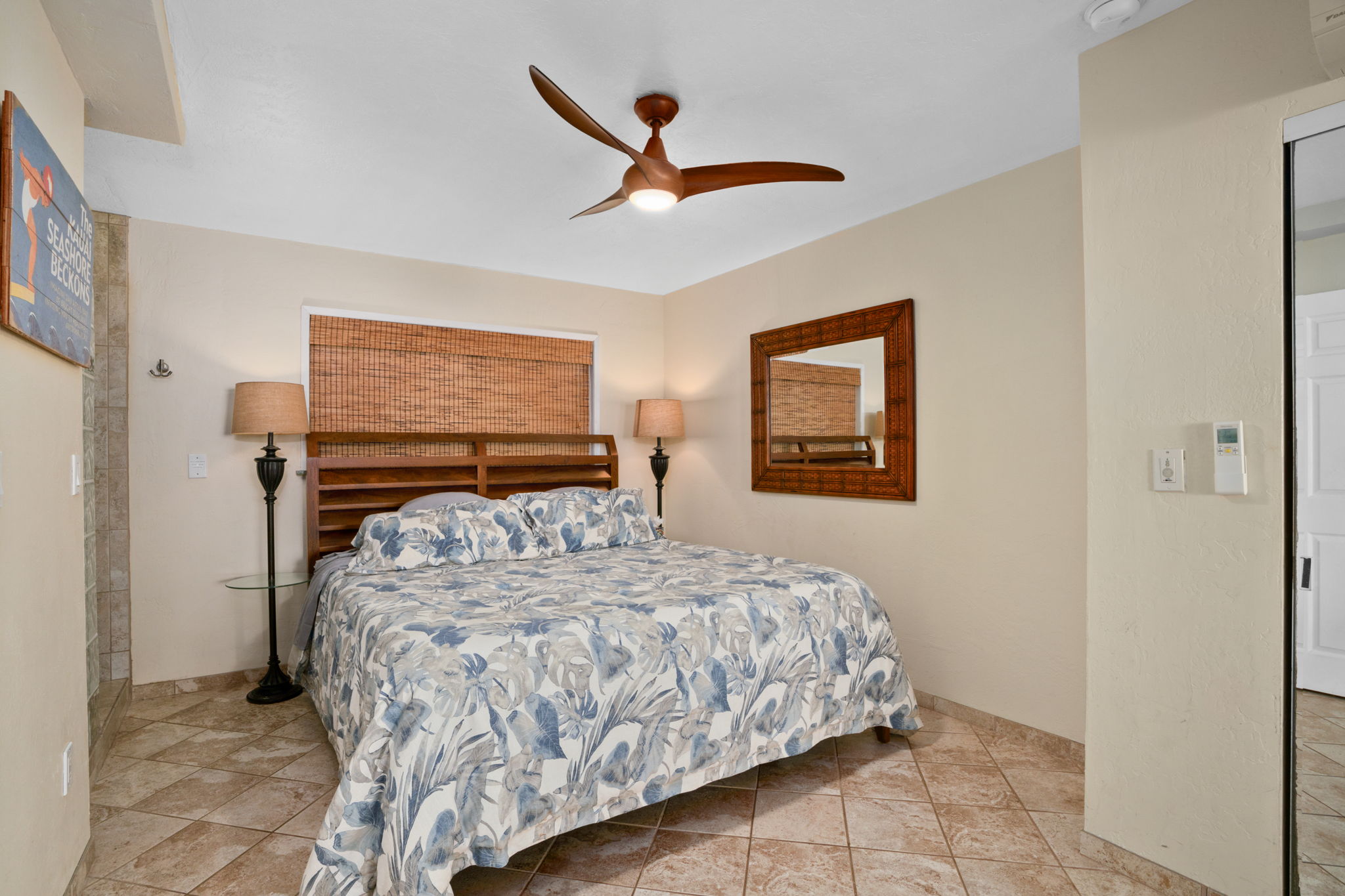 5050 Lawai Road, Unit 311 Koloa, HI 96756 - Photo 11 of 21 a bedroom with a bed and a ceiling fan