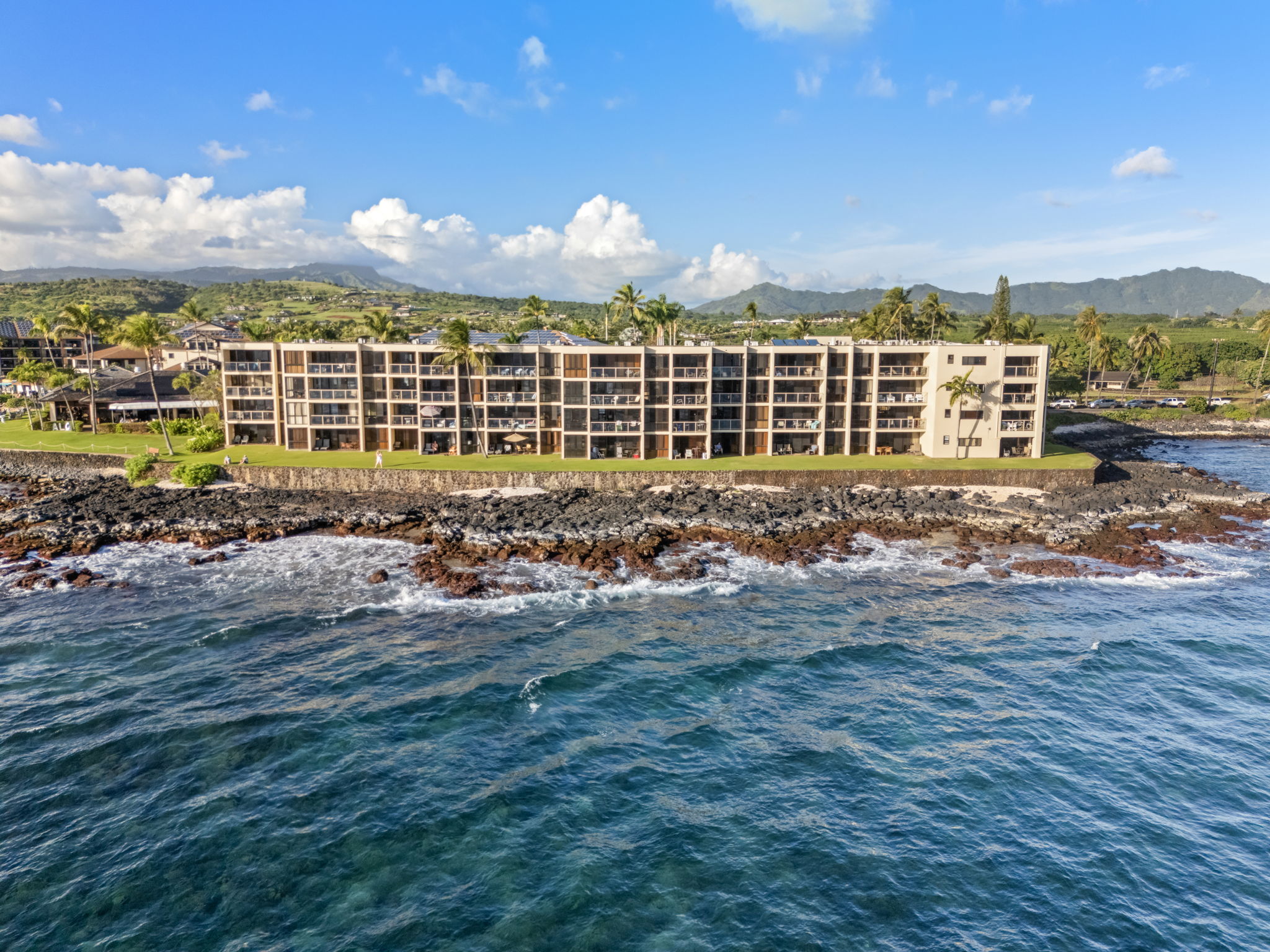5050 Lawai Road, Unit 311 Koloa, HI 96756 - Photo 20 of 21 a front view of building with yard and ocean view