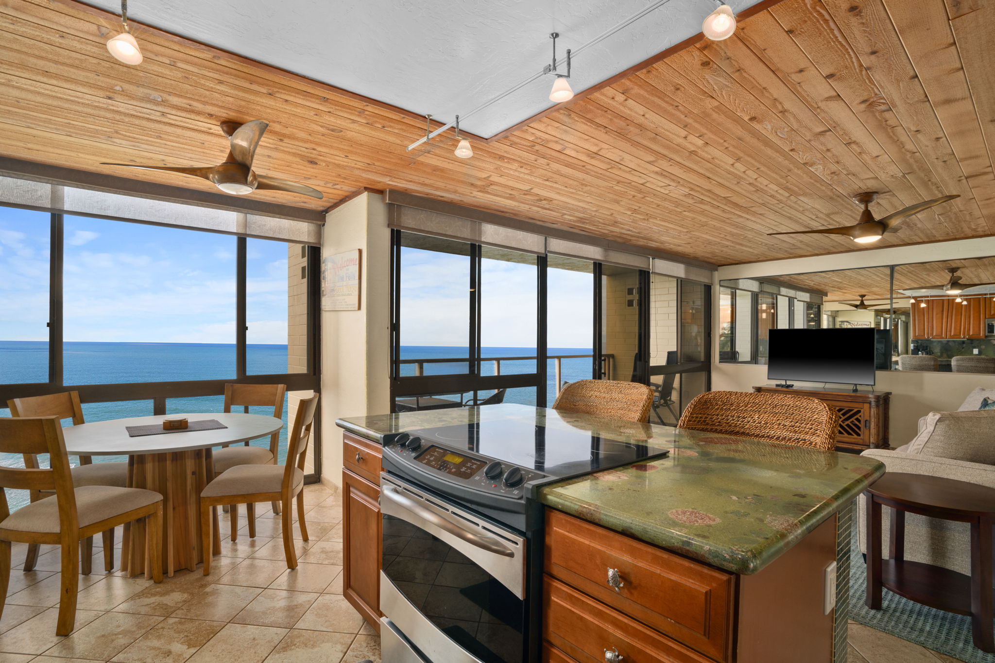 5050 Lawai Road, Unit 311 Koloa, HI 96756 - Photo 4 of 21 a kitchen with stainless steel appliances granite countertop a stove a sink and a dining table