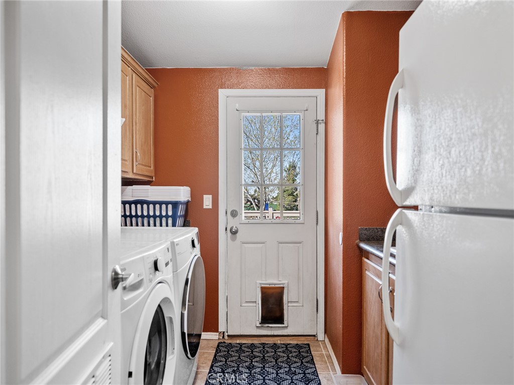 2826 Marco Road Phelan, CA 92371 - Photo 21 of 33 a view of a hallway with washer and dryer