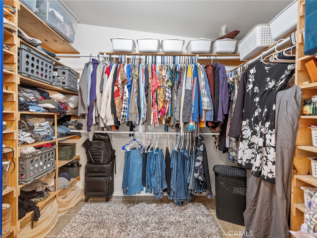 2826 Marco Road Phelan, CA 92371 - Photo 25 of 33 a view of walk in closet with clothes