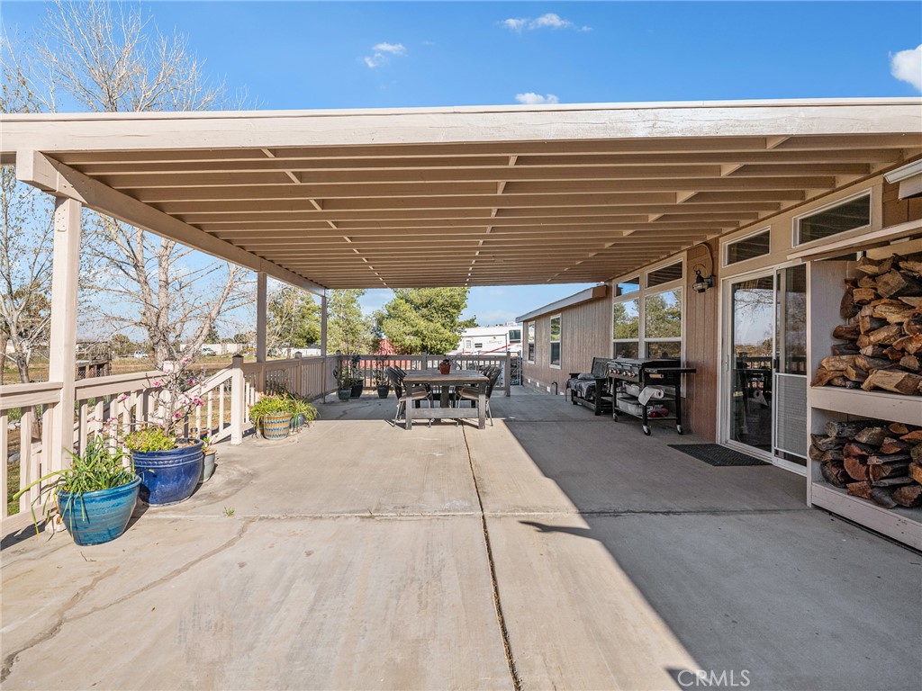 2826 Marco Road Phelan, CA 92371 - Photo 26 of 33 a view of a patio with table and chairs potted plants