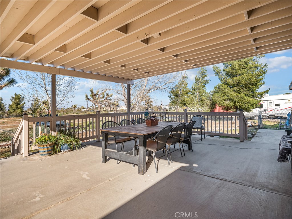 2826 Marco Road Phelan, CA 92371 - Photo 27 of 33 a view of a patio with a table and chairs under an umbrella