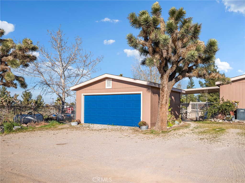 2826 Marco Road Phelan, CA 92371 - Photo 28 of 33 a front view of a house with a yard and garage