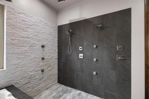 a bathroom with a shower and a sink