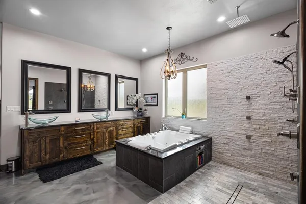 a spacious bathroom with a double vanity sink large mirror and a bathtub