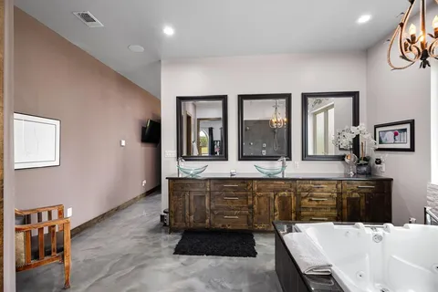 a large bathroom with a tub and sink