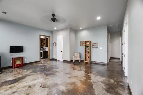 a view of an empty room with closet and a window