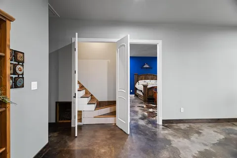 a view of a livingroom with furniture and stairs