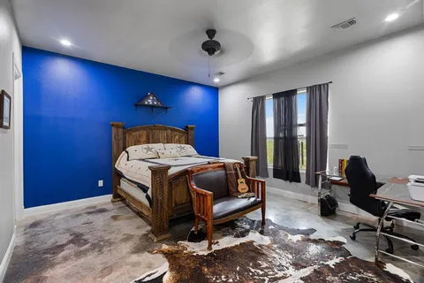 a bedroom with a bed a desk and chair