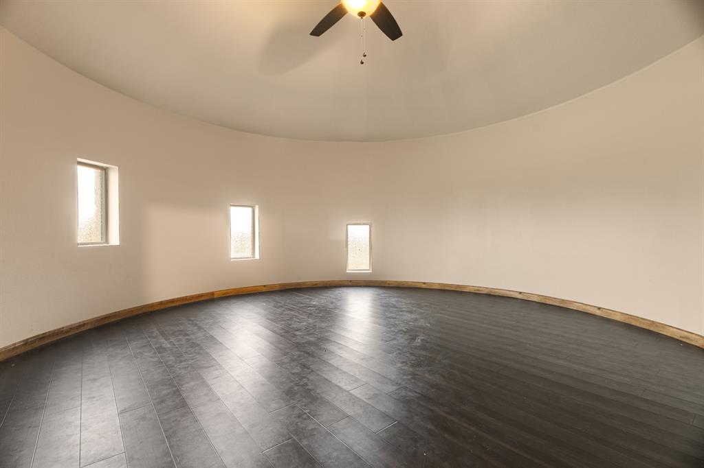 1395 Private Road 4011 Decatur, TX 76234 - Photo 27 of 34 an empty room with wooden floor and windows