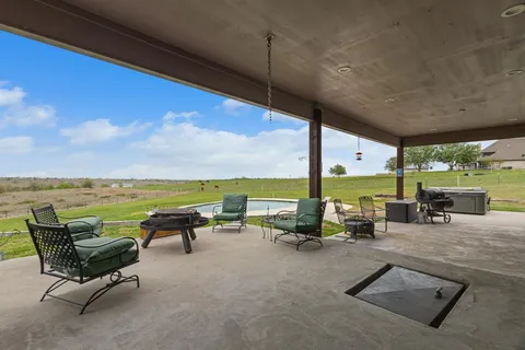a view of swimming pool with outdoor seating space
