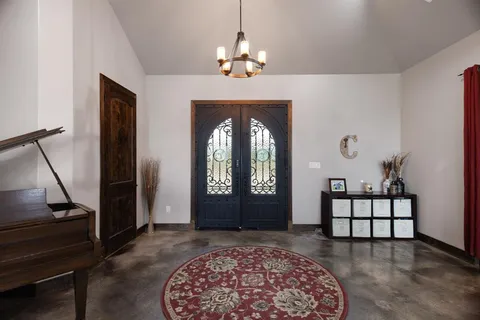 a living room with furniture and a chandelier