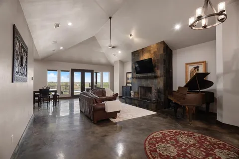 a living room with fireplace furniture and a flat screen tv
