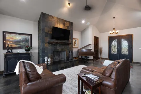 a living room with furniture a flat screen tv and a fireplace