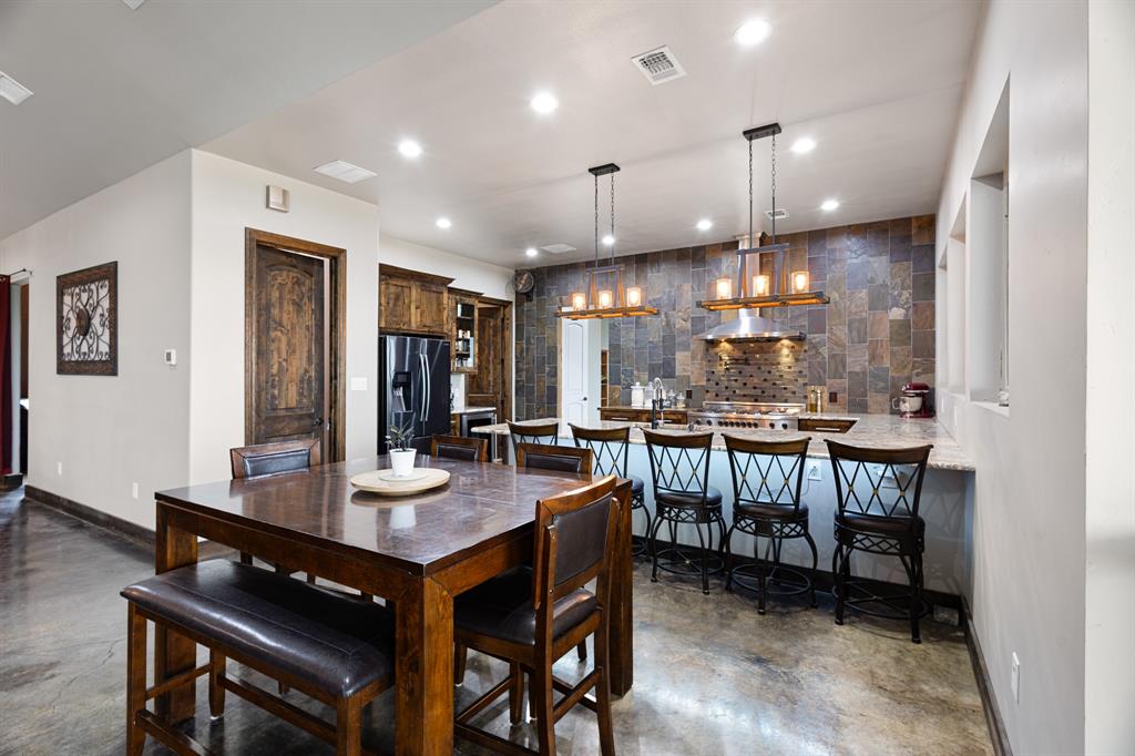 1395 Private Road 4011 Decatur, TX 76234 - Photo 7 of 34 a kitchen with a dining table chairs and wooden floor