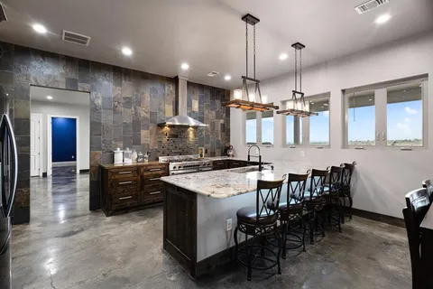 a large kitchen with a table and chairs